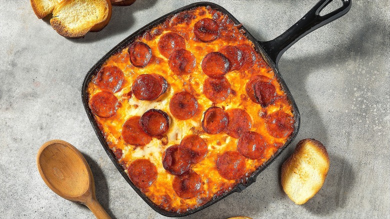 Square cast iron pan with baked pizza dip