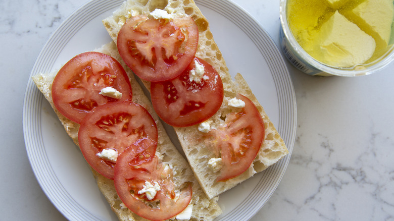 Two slices of French bread topped with sliced tomatoes
