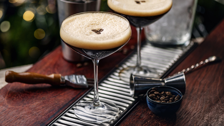 Espresso martinis in stem glasses with coffee beans on a bar