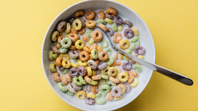 Froot Loops in a bowl of milk on a yellow background