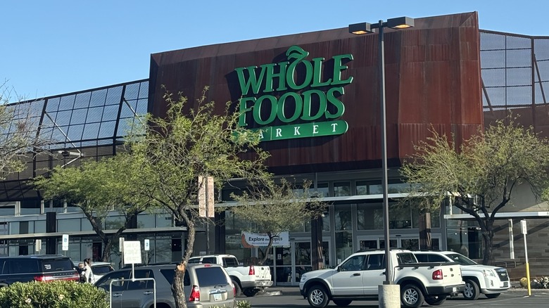 Whole Foods sign framed by trees in the forefront