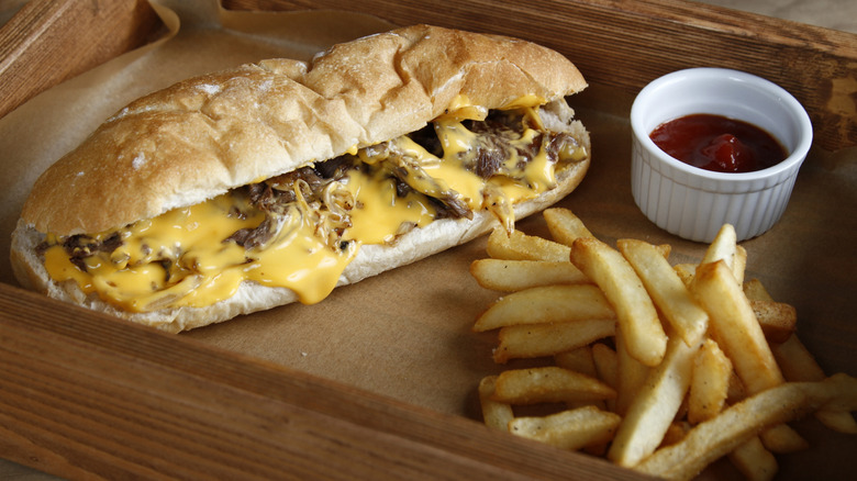 Philly cheesesteak sandwich with fries