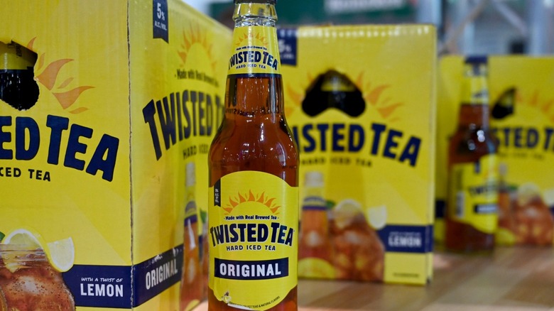 A bottle of Twisted Tea in front of large packs of Twisted Tea