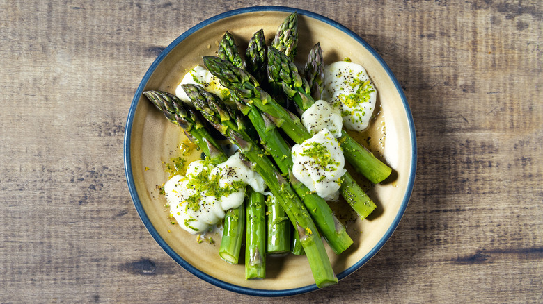 plate of cooked asparagus with cheese