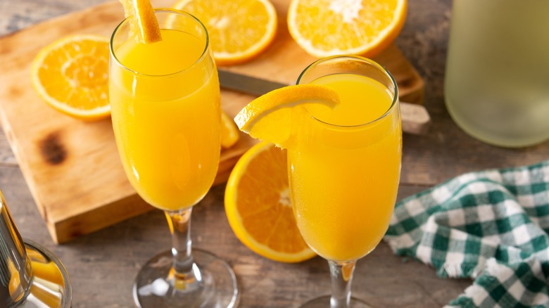 Two glasses of mimosa with orange slices