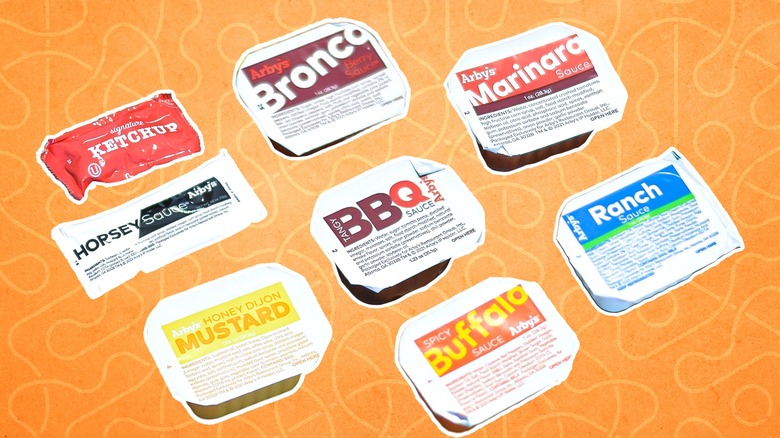 A collection of Arby's sauces on yellow background