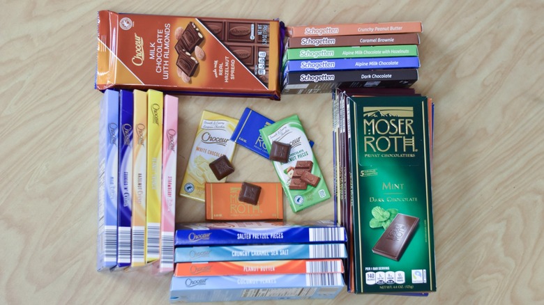 Aldi chocolate bars arranged in a square with chocolate squares in the middle on a wooden table