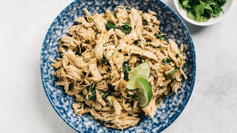 Shredded chicken in a blue bowl