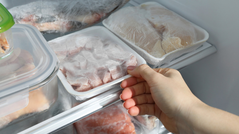 person taking meat out of freezer
