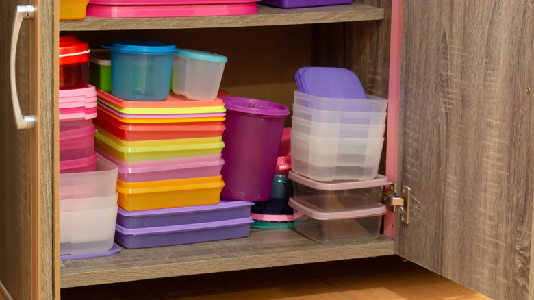 kitchen cabinet full of plastic storage containers