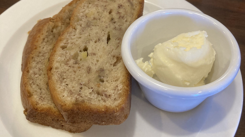 A plate of Bob Evans banana bread accompanied by butter.