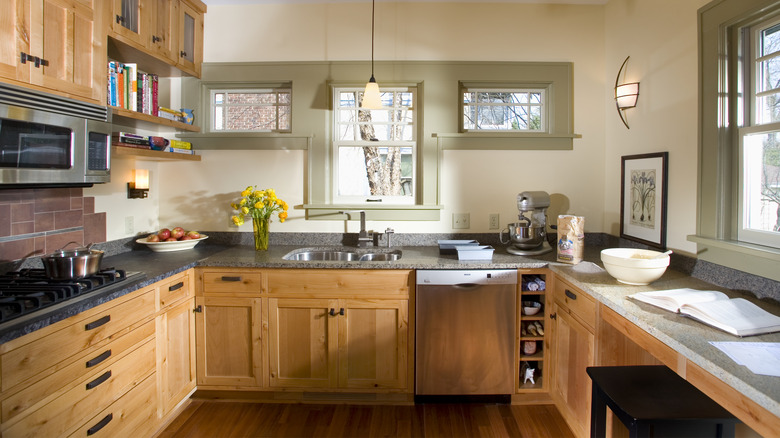 A kitchen with spacious wooden cabinets
