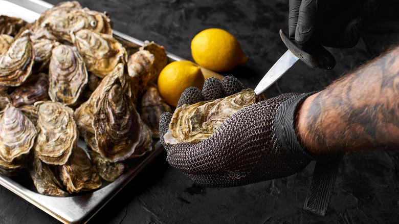 Freshly shucked oysters with knife