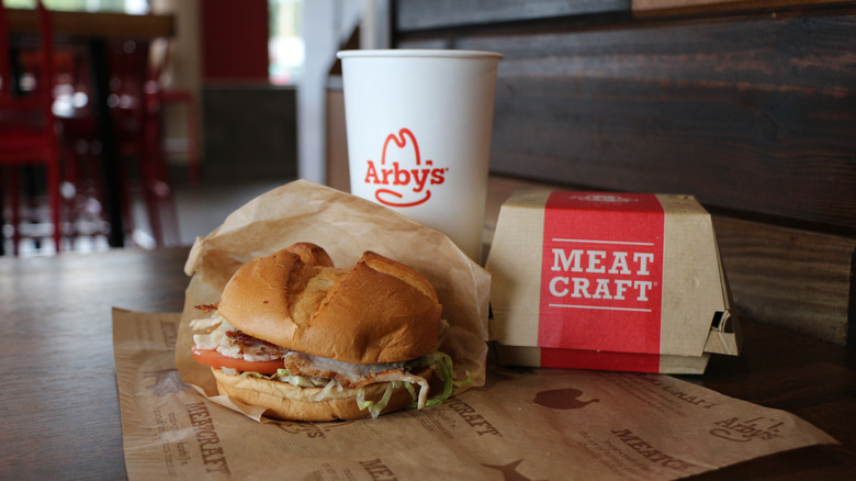 Arby's sandwich and drink on a table