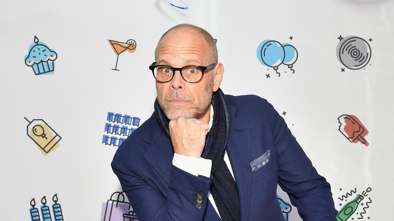 Alton Brown resting his chin on his hand