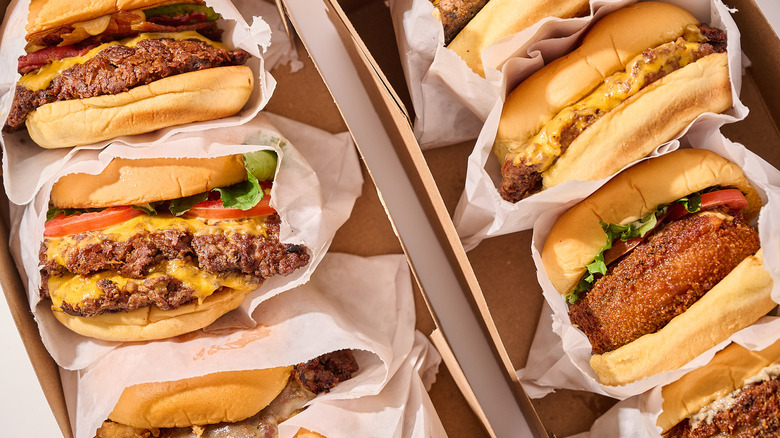 Hamburgers inside of boxes on a table