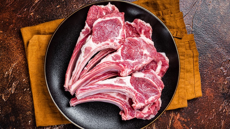 A plate of raw lamb chops