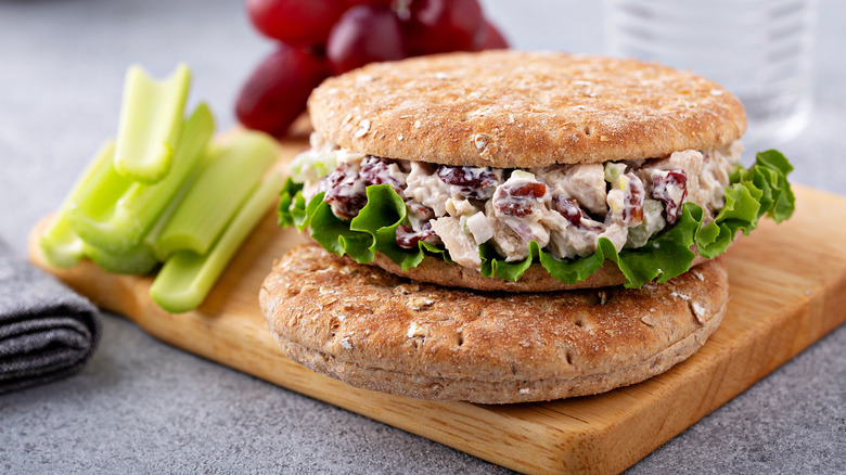 Chicken salad sandwich on cutting board