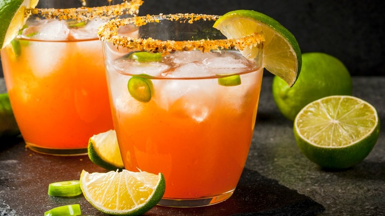 Spicy orange cocktail with limes and peppers