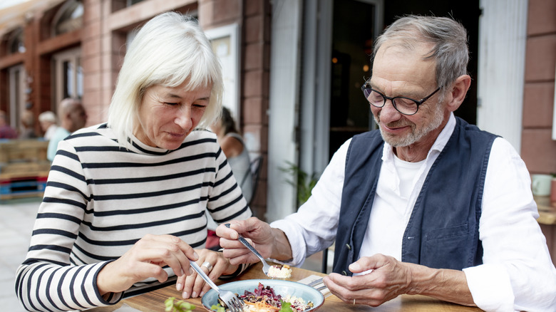 Two seniors eating at a restaurant