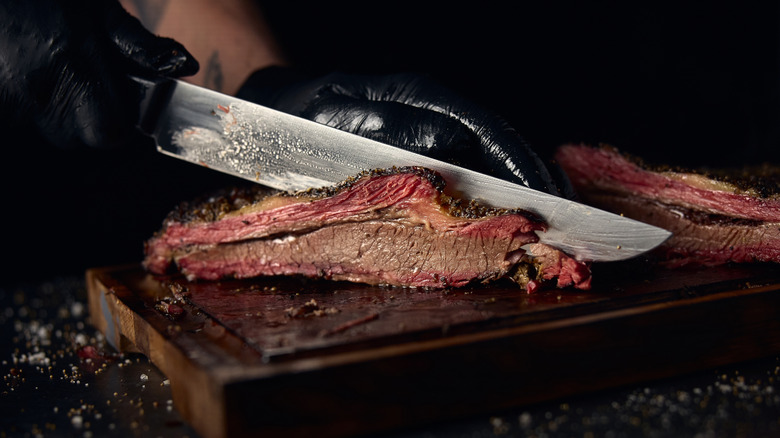 chef slicing smoked brisket