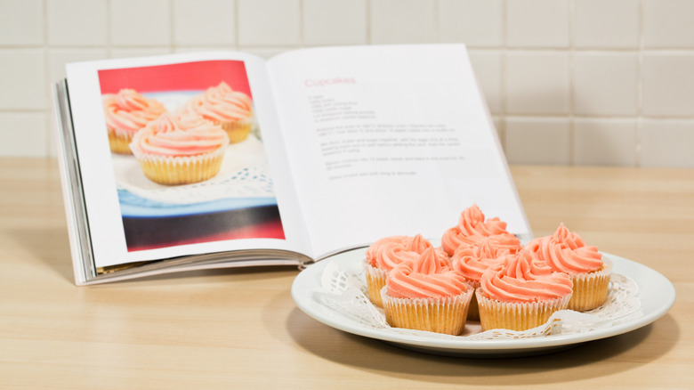 Cookbook and plate of cupcakes