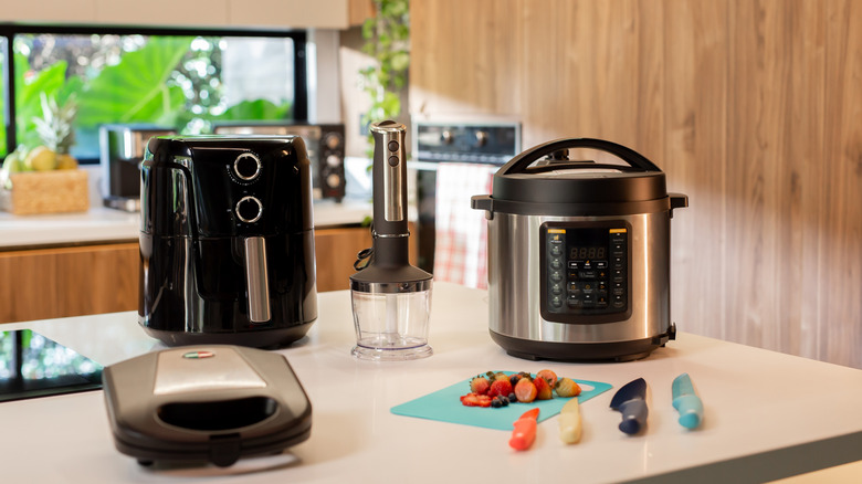Small appliances and kitchen tools on top of a kitchen island