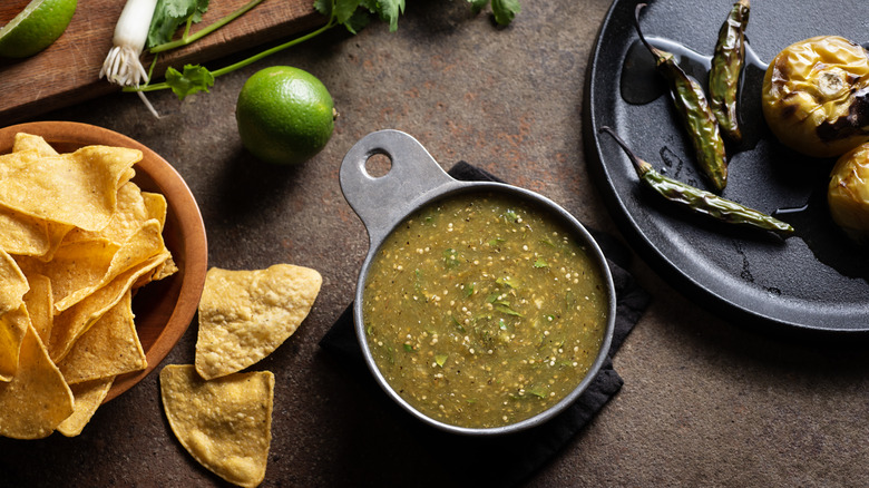 Roasted tomatillo salsa verde with chips and chiles