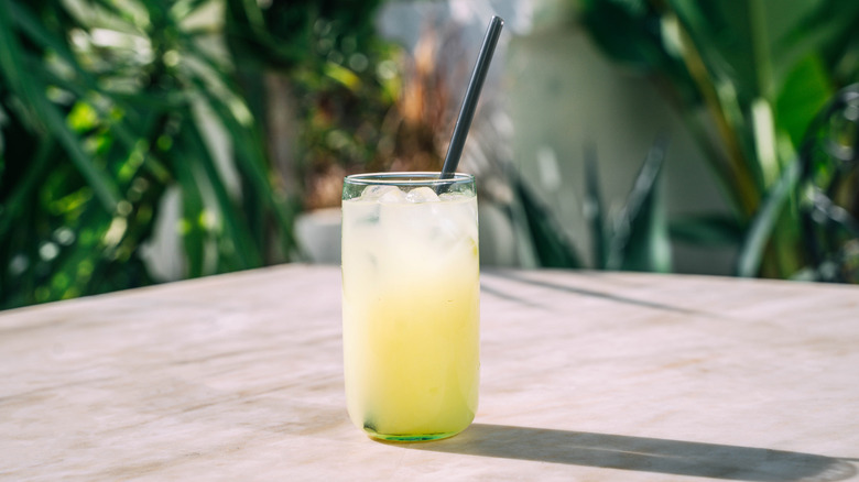 A glass of lemonade on a wooden table