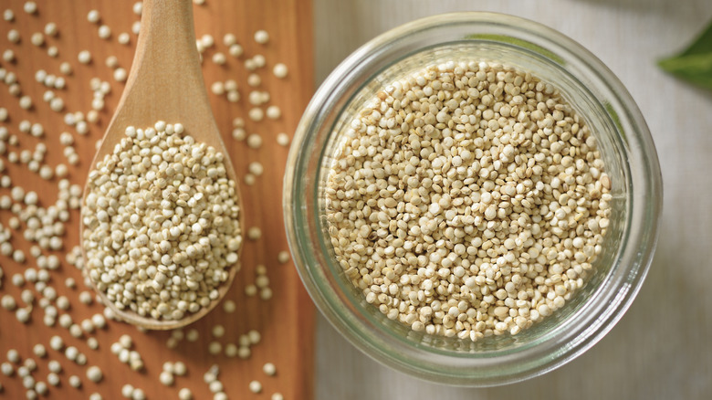 Quinoa in a glass container with a spoon on the side