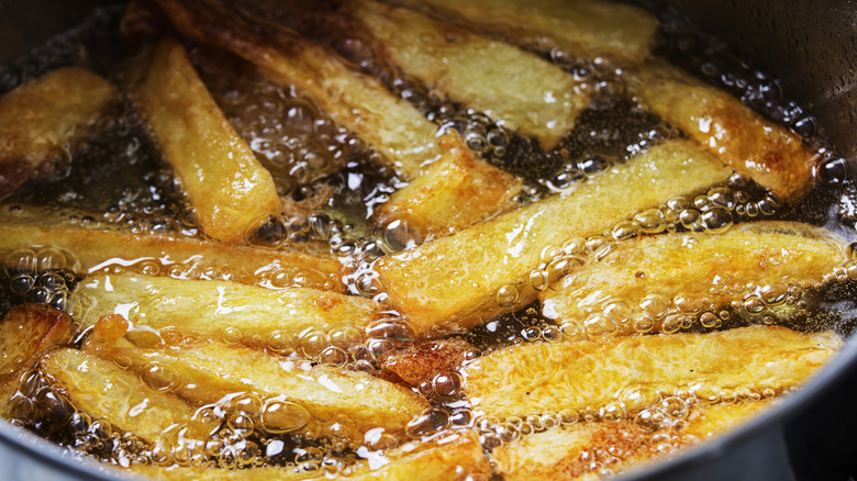 Close up of French fries in oil
