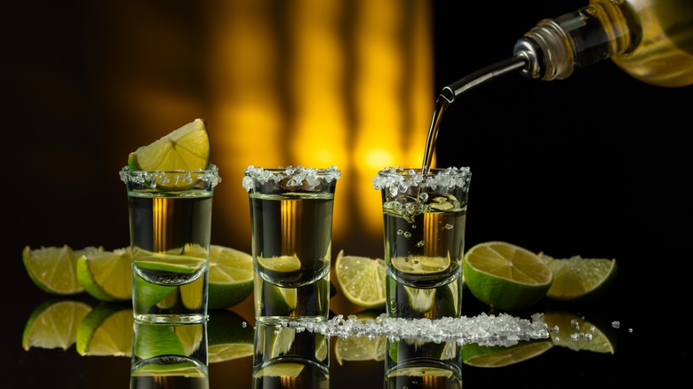 Shots of tequila with limes and salt