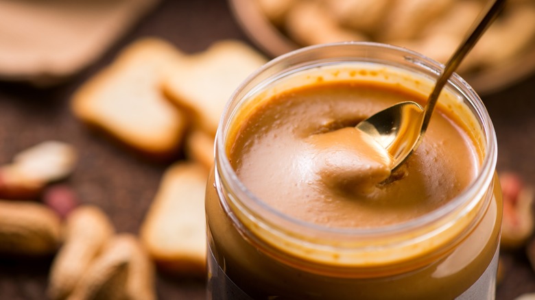 A spoon in a peanut butter jar