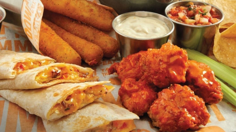 Various Applebee's appetizers laid out on a table