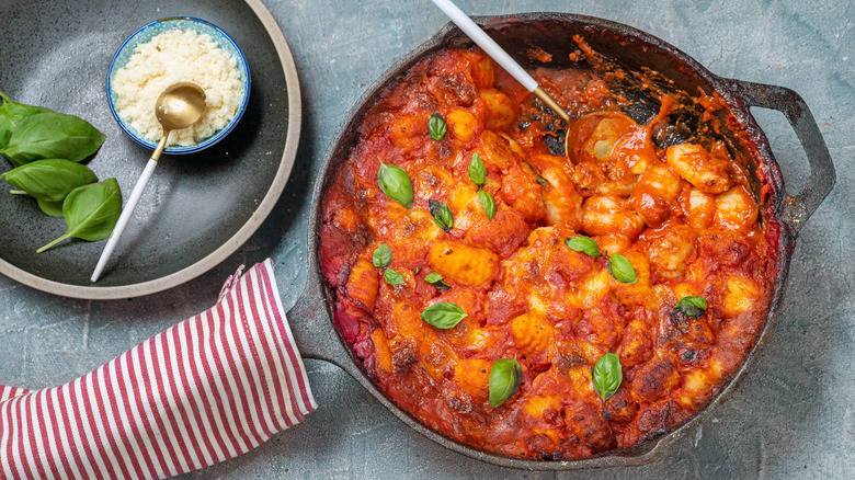 Tomato-based pasta in a cast iron skillet.