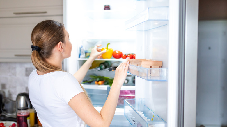 Person taking food out of the fridge
