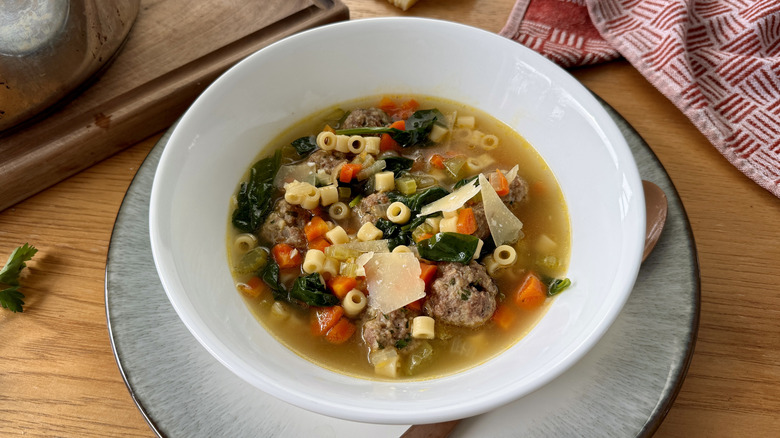 vegetable, meatball, and pasta soup in white bowl