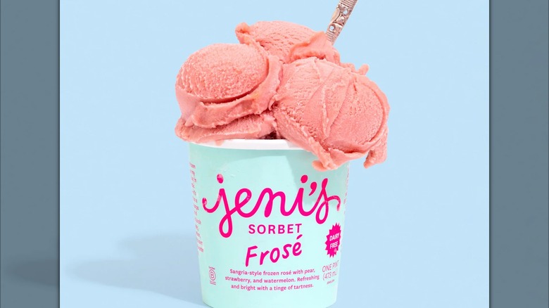 A pint of Jeni's frose sorbet on a blue background