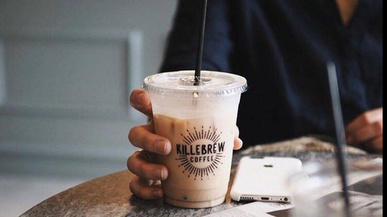 A female customer enjoying a Killebrew iced coffee