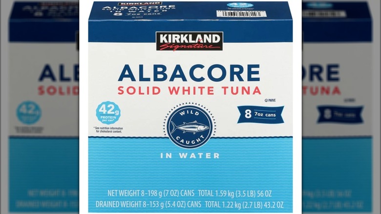 A box of Kirkland Signature albacore solid white tuna cans