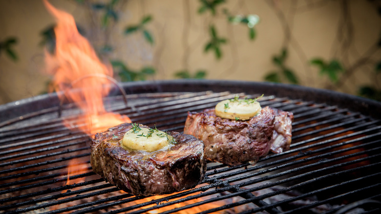 Two steaks on a charcoal grill