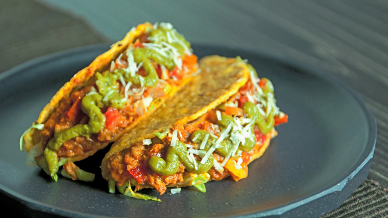 Two ground beef tacos on a plate