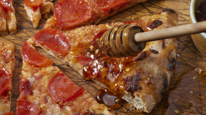 A pepperoni pizza with hot honey drizzled over top
