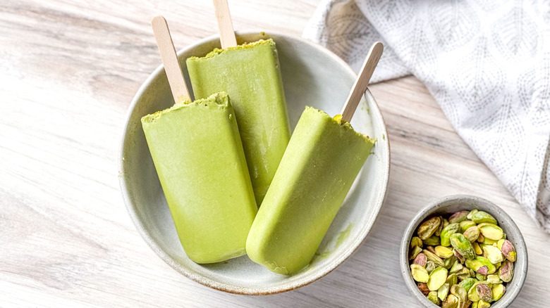 Matcha pistachio popsicles in bowl with pistachios