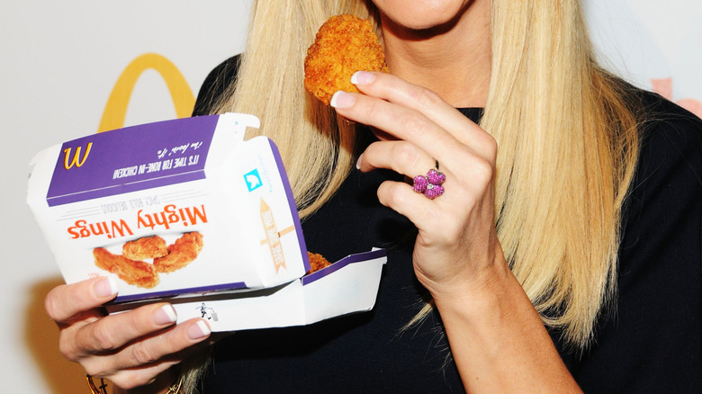 Woman holding McDonald's Mighty Wings