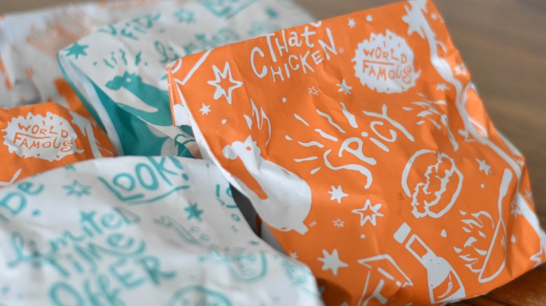 A Popeyes spicy chicken sandwich in the store's packaging