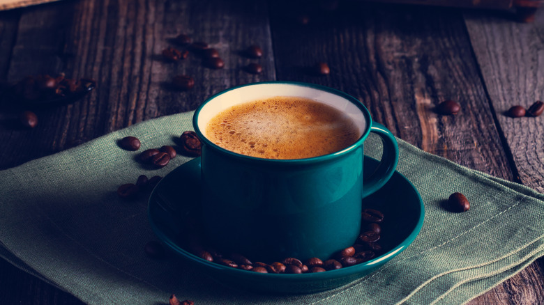 A classic mug of coffee with beans