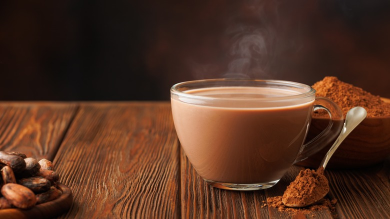 hot cocoa with powder and beans on table