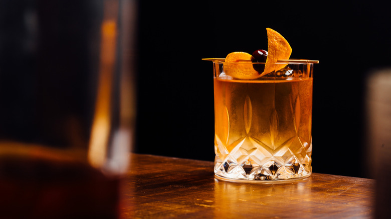 Close up Old Fashioned with orange peel and cherry garnish