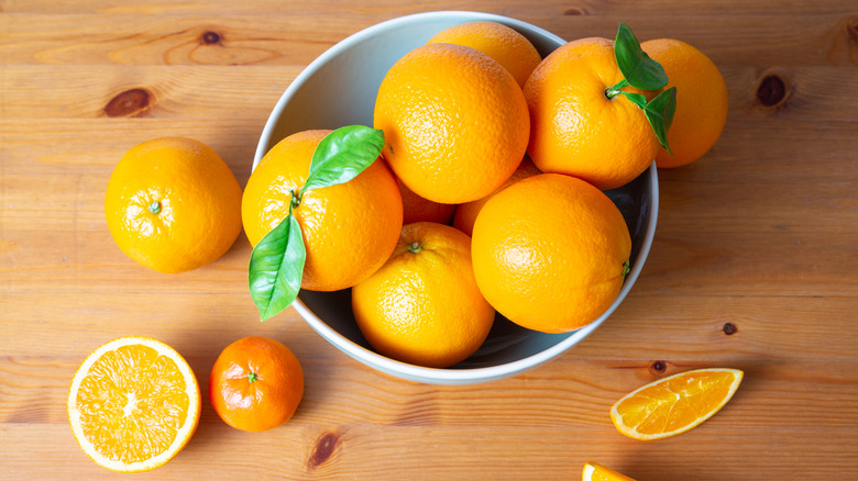 Bowl of oranges on a wooden table